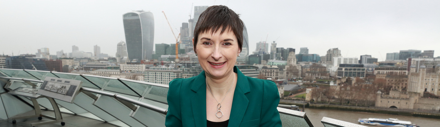 Photo of Baroness Caroline Pidgeon MBE in front of the London skyline